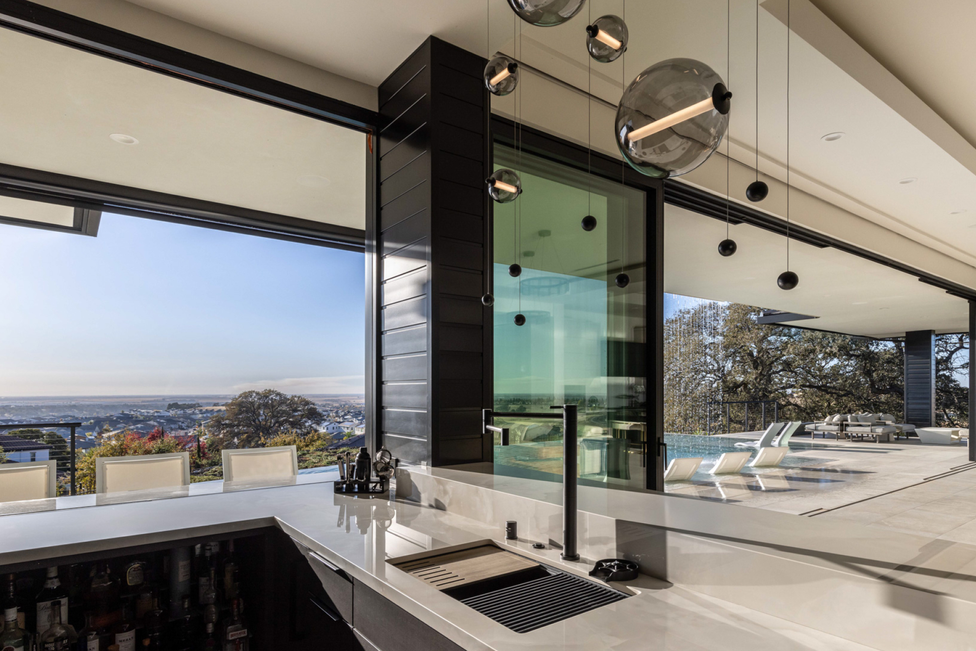 Modern kitchen with sleek black accents, minimalistic design, and stunning views in Lincoln, CA.