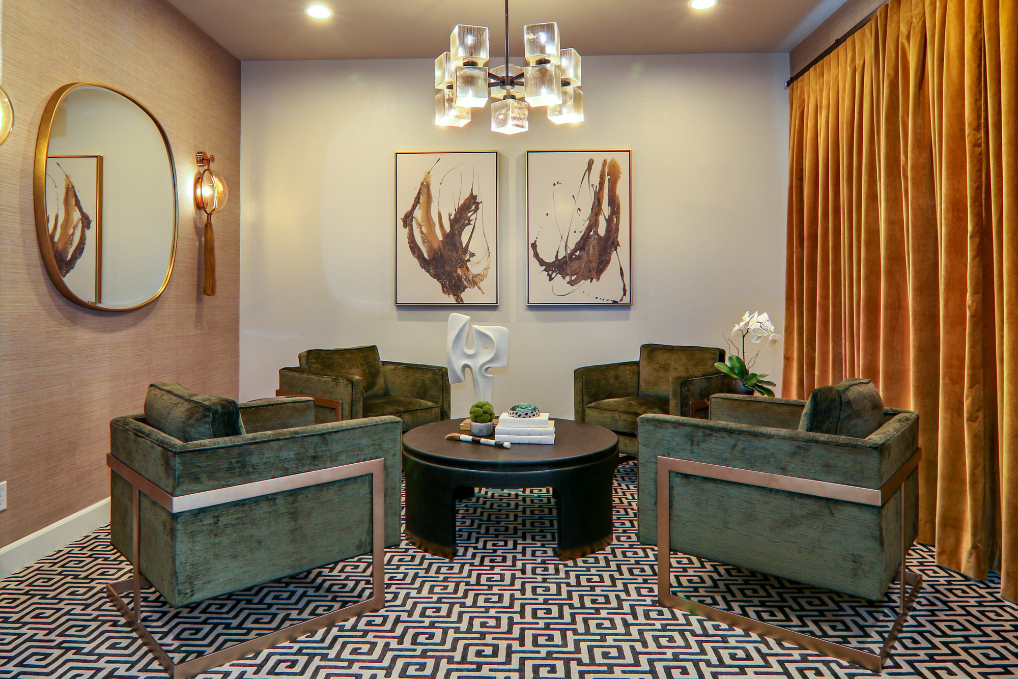 Contemporary sitting room in Lincoln, CA featuring green velvet chairs, geometric carpet, and modern artwork.