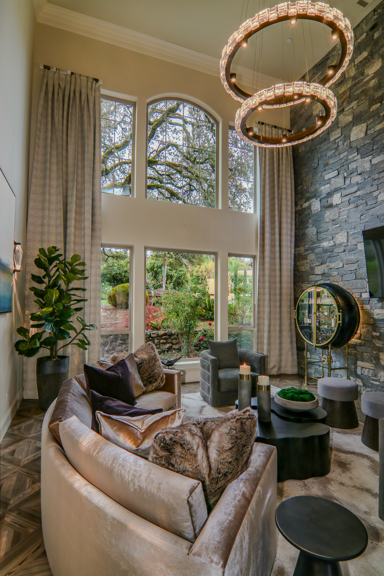 Modern living room featuring plush seating, elegant lighting, and large windows in Lincoln, CA