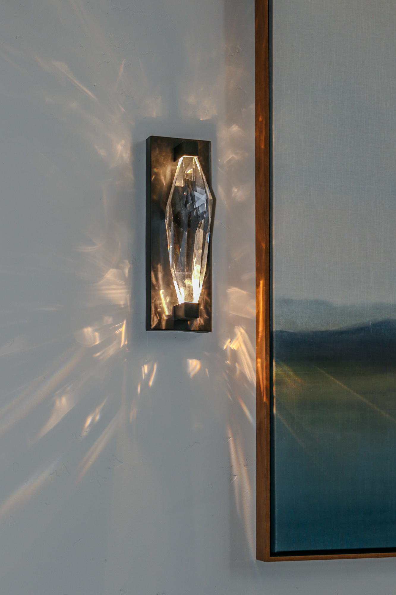 Contemporary living room remodel featuring a diamond light fixture and modern artwork in Lincoln, CA.