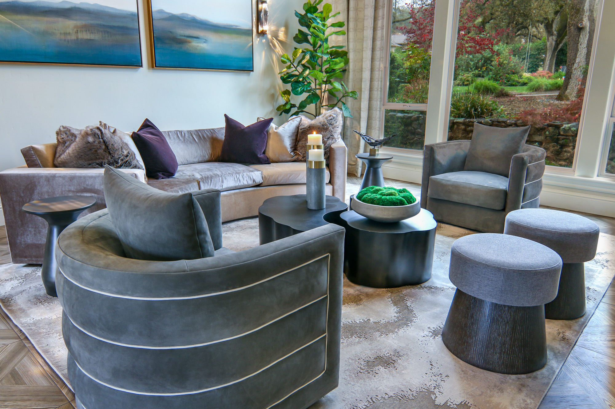 Modern living room design in Lincoln, CA featuring a plush gray sofa, stylish chairs, and decorative elements