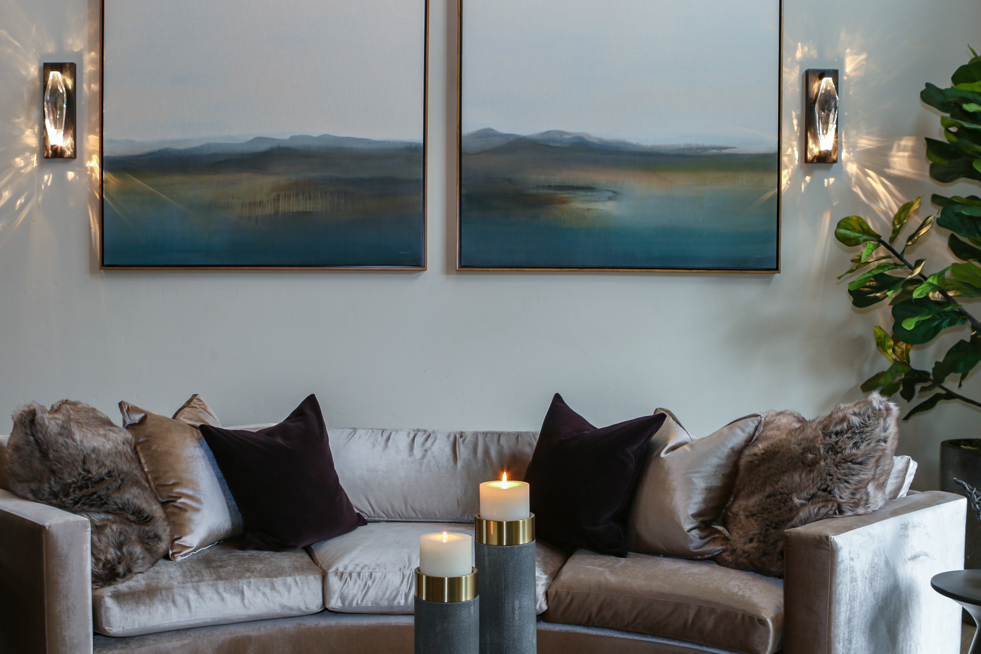Luxurious living room in Lincoln, CA featuring a curved velvet sofa, accented pillows, and modern artwork.