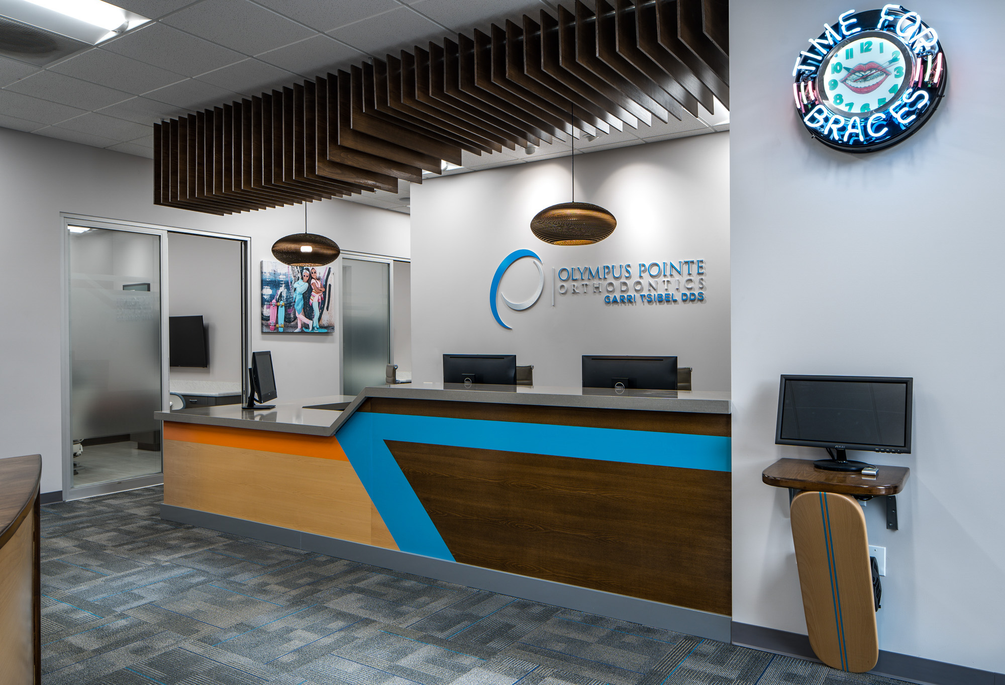 Modern dental office reception area with a stylish desk and vibrant blue accents in Roseville, CA.
