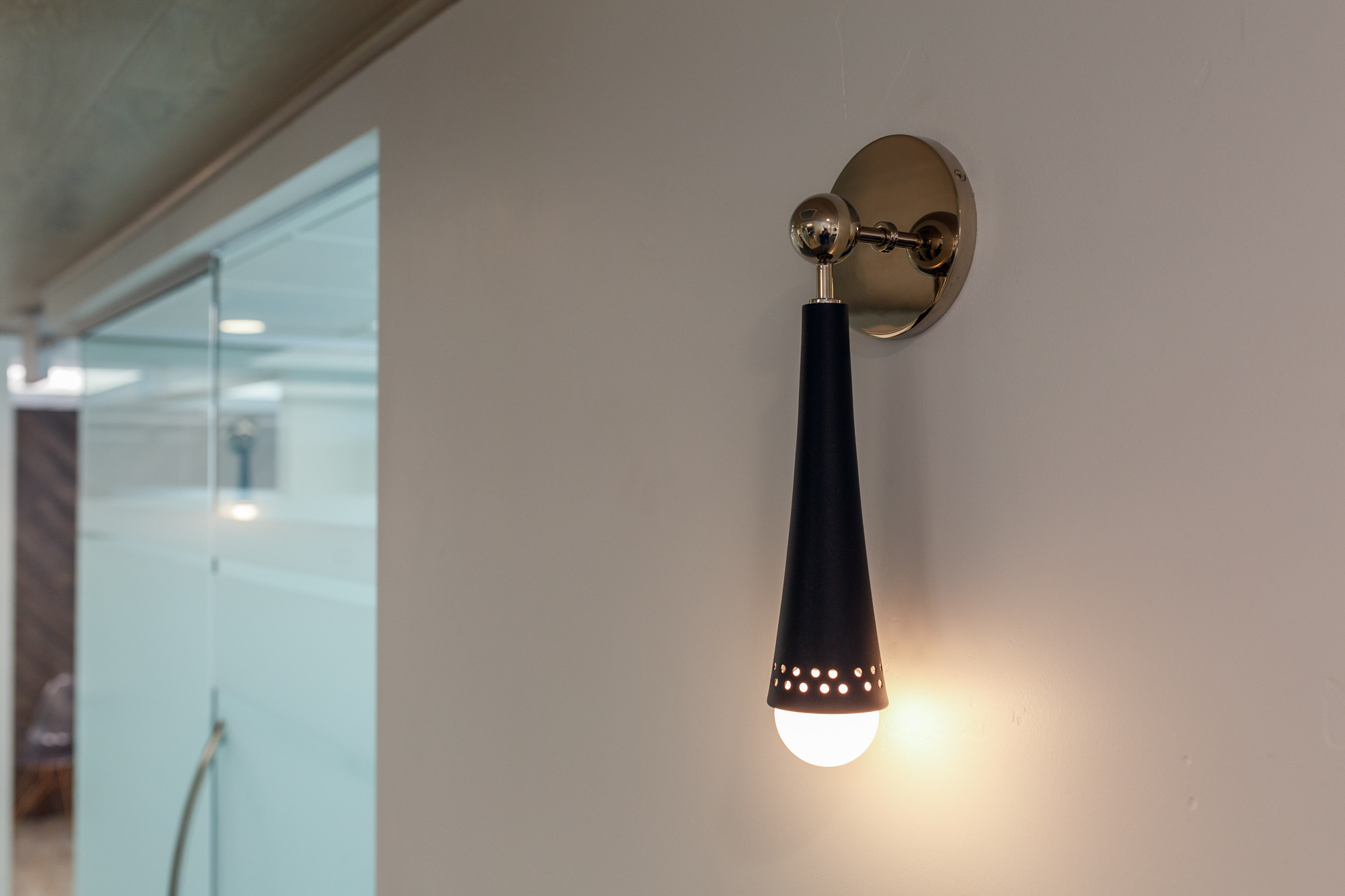Modern dental office lighting design featuring a stylish black and gold wall sconce in roseville, california.