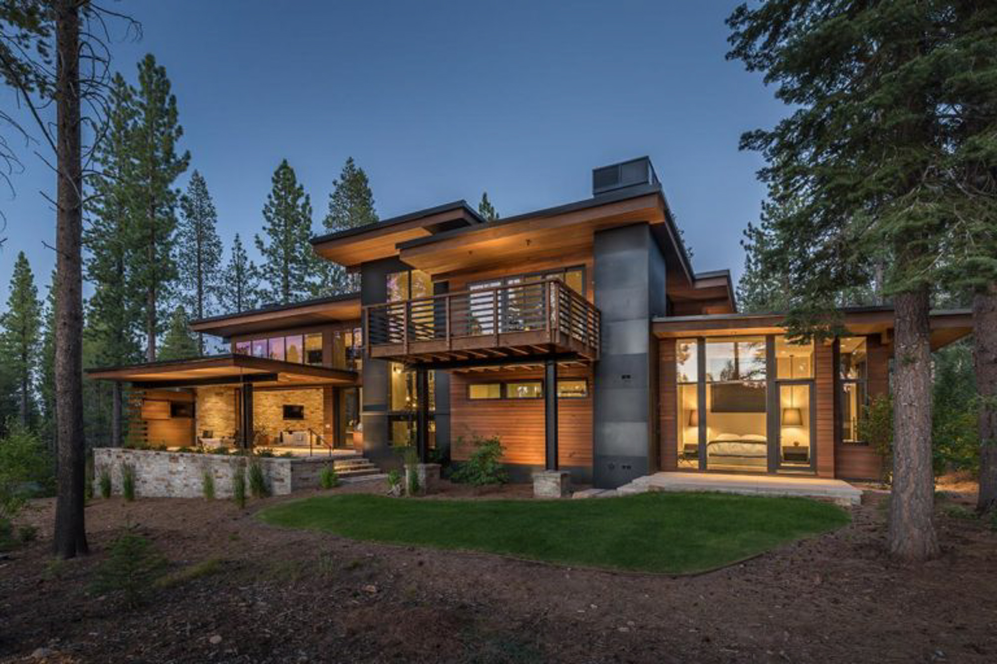 Modern exterior of a luxury home featuring large windows and wood accents in Martis Camp, Truckee, CA