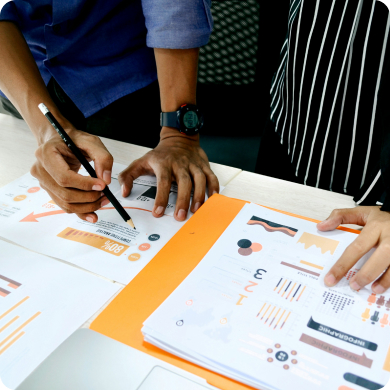 Nonprofit fundraising team reviewing campaign strategy documents and analytics during planning meeting