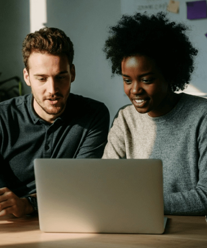 Diverse nonprofit team reviewing digital campaign performance data on laptop