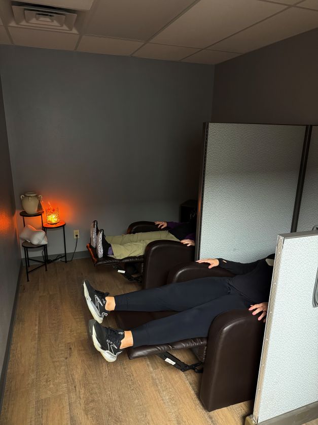 Two patients resting in the resting suite at Atlas Specific Chiropractic after an adjustment. 