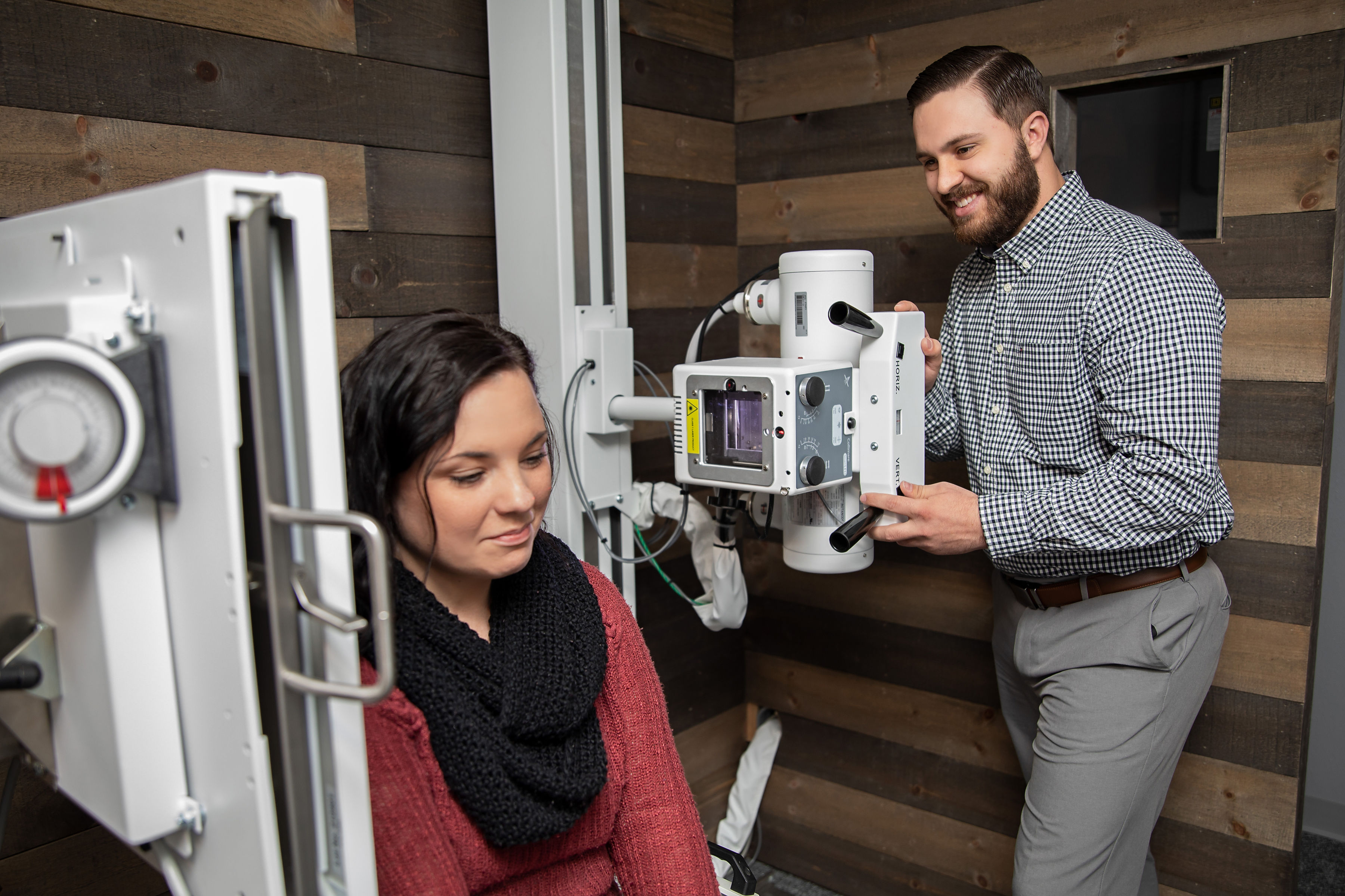 Dr. Reis taking x-rays of a female patient's neck for use in determining the size and vector of misalignment.