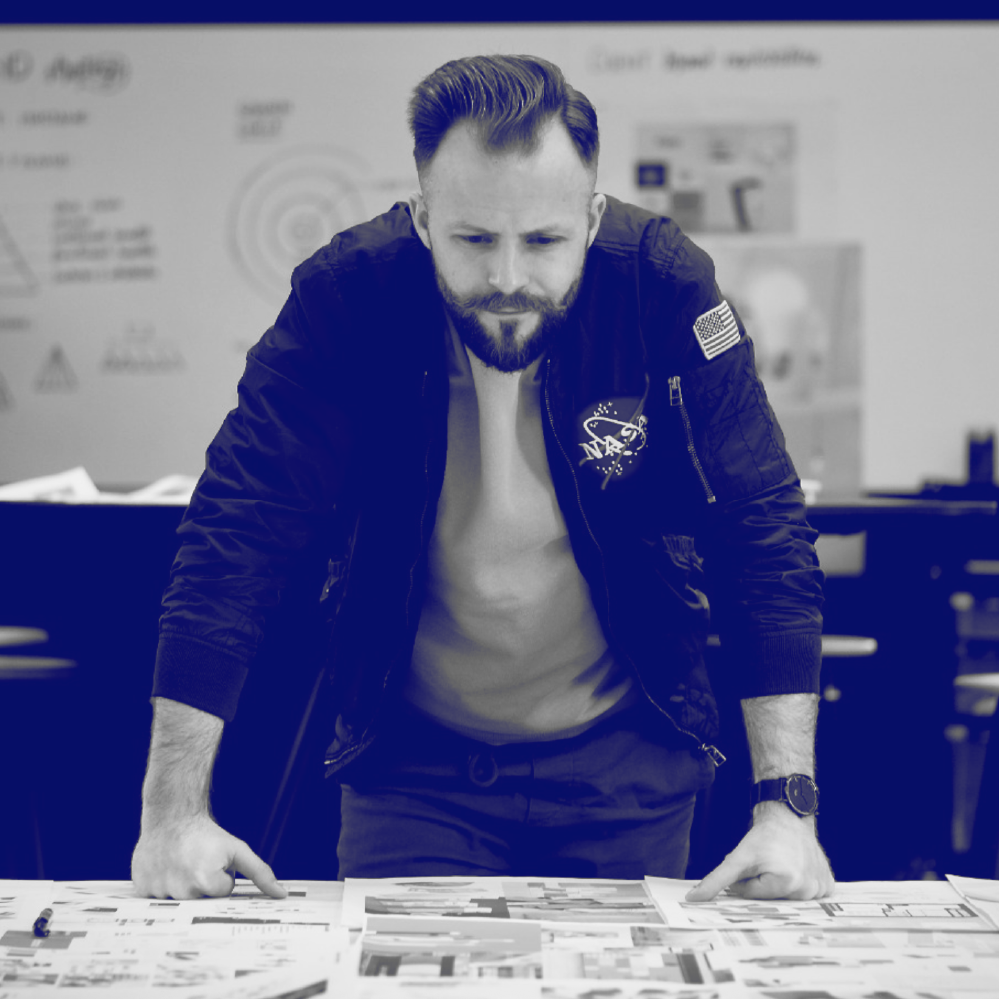 Sean Loomis Standing at a Table of Design Options