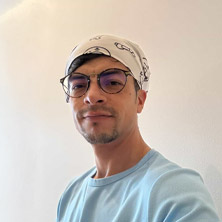 Marc Groomer Head shot with a bandana and glasses on