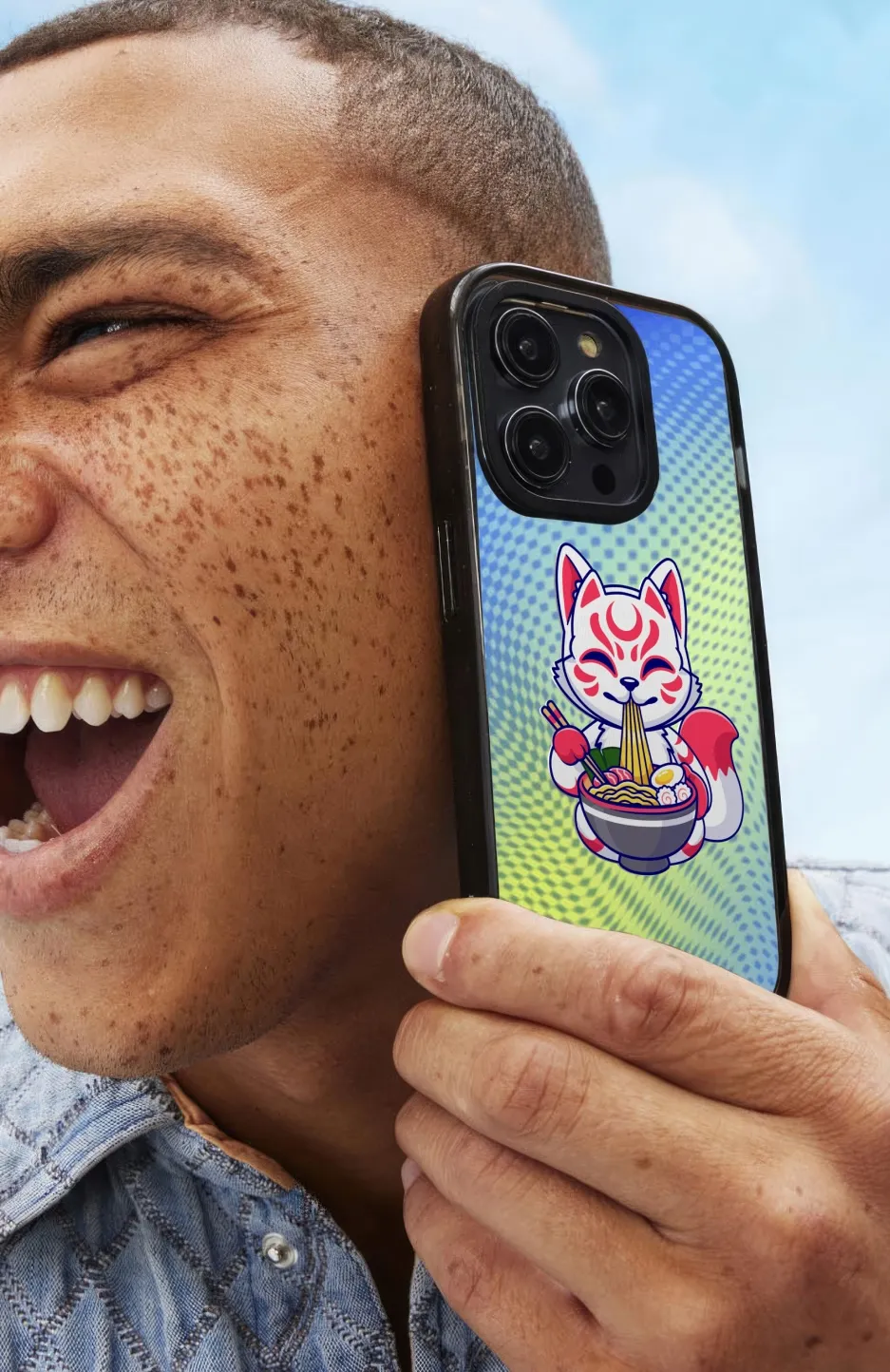 A man holding a cell phone up to his face.