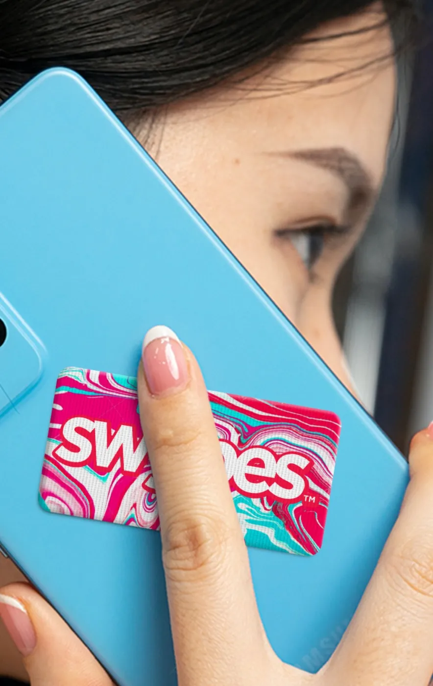 A woman holding a cell phone up to her face.