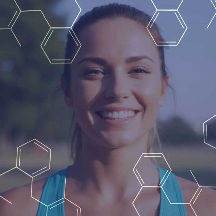 Smiling young woman with hair pulled back wearing a teal tank top, outdoors with a background of trees, overlaid with transparent hexagonal chemical shapes.