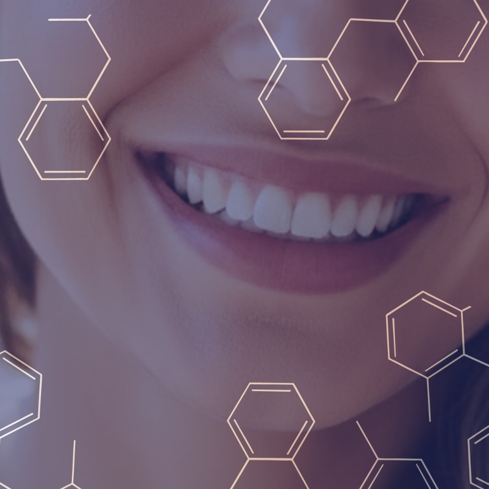 Close-up of a smiling woman’s mouth showing white teeth with molecular structure overlays.