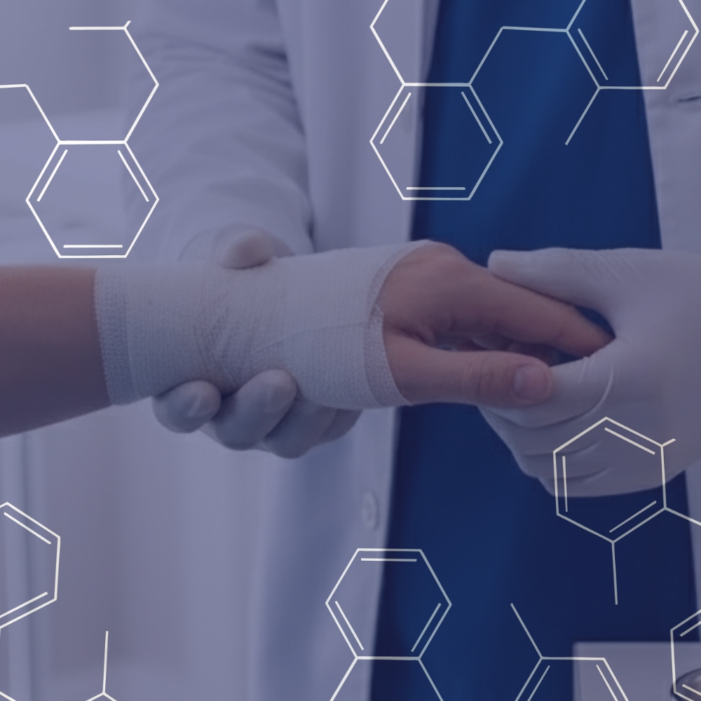 Medical professional wearing gloves wrapping a bandage around a patient's wrist.