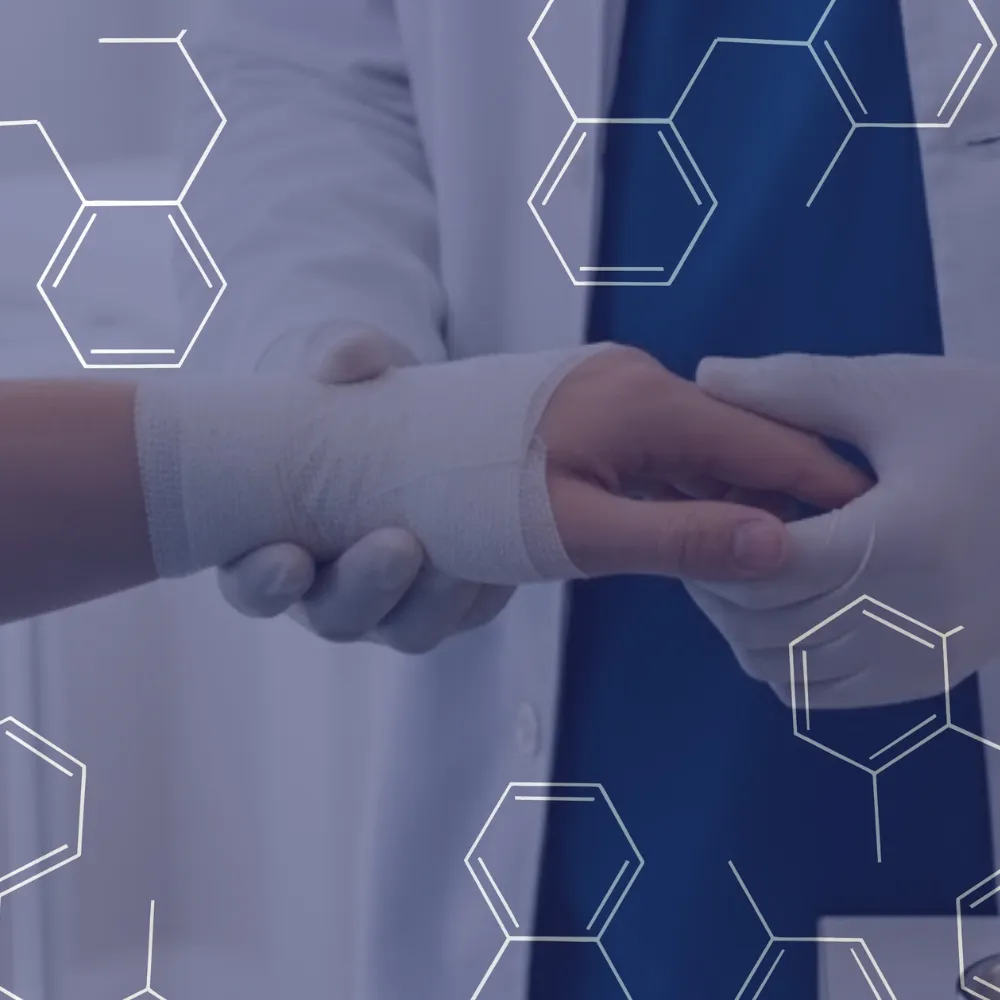 Medical professional wearing gloves wrapping a bandage around a patient's wrist.