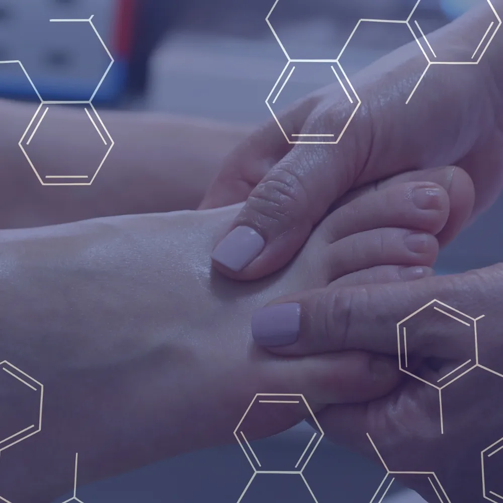 Hands gently massaging a foot, symbolizing podiatry care.