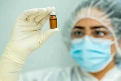 Lab technician handling ingredients for custom compounding at Thesis Pharmacy