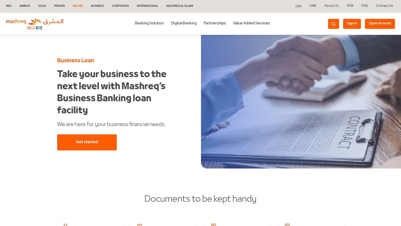 A business owner reviewing an SME business loan contract agreement from Mashreq NEOBiz