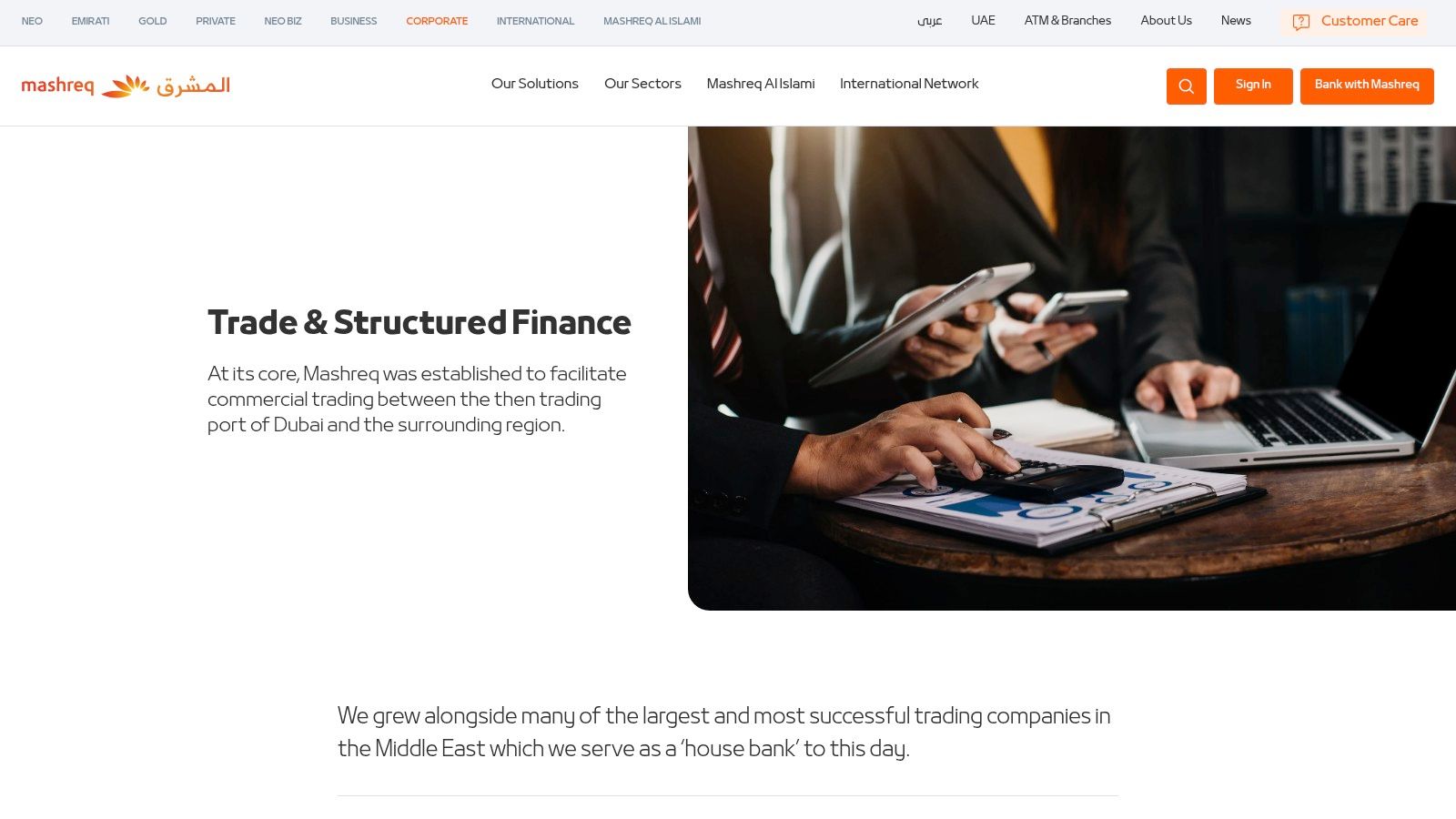 A team of professionals collaborating in an office setting, representing Mashreq's corporate services.