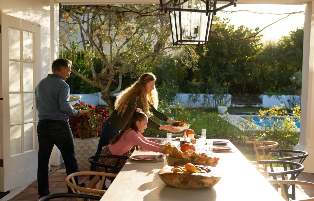 A family gathering on the terrace of a vetted luxury finca, showcasing the private lifestyle curated for our American clientele.