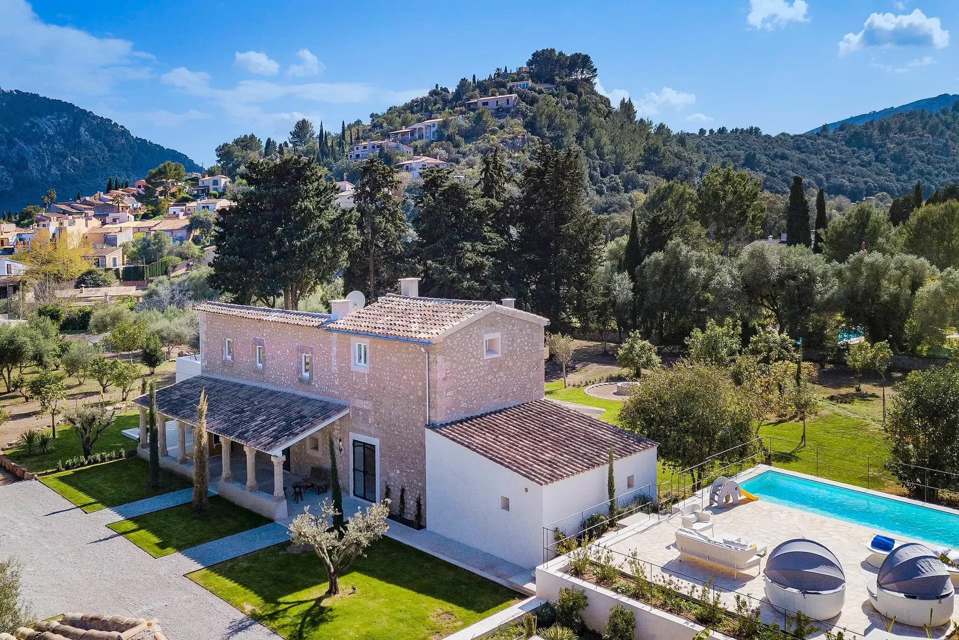 An authentic stone finca blending traditional architecture with modern luxury, featuring manicured gardens and high-end privacy.