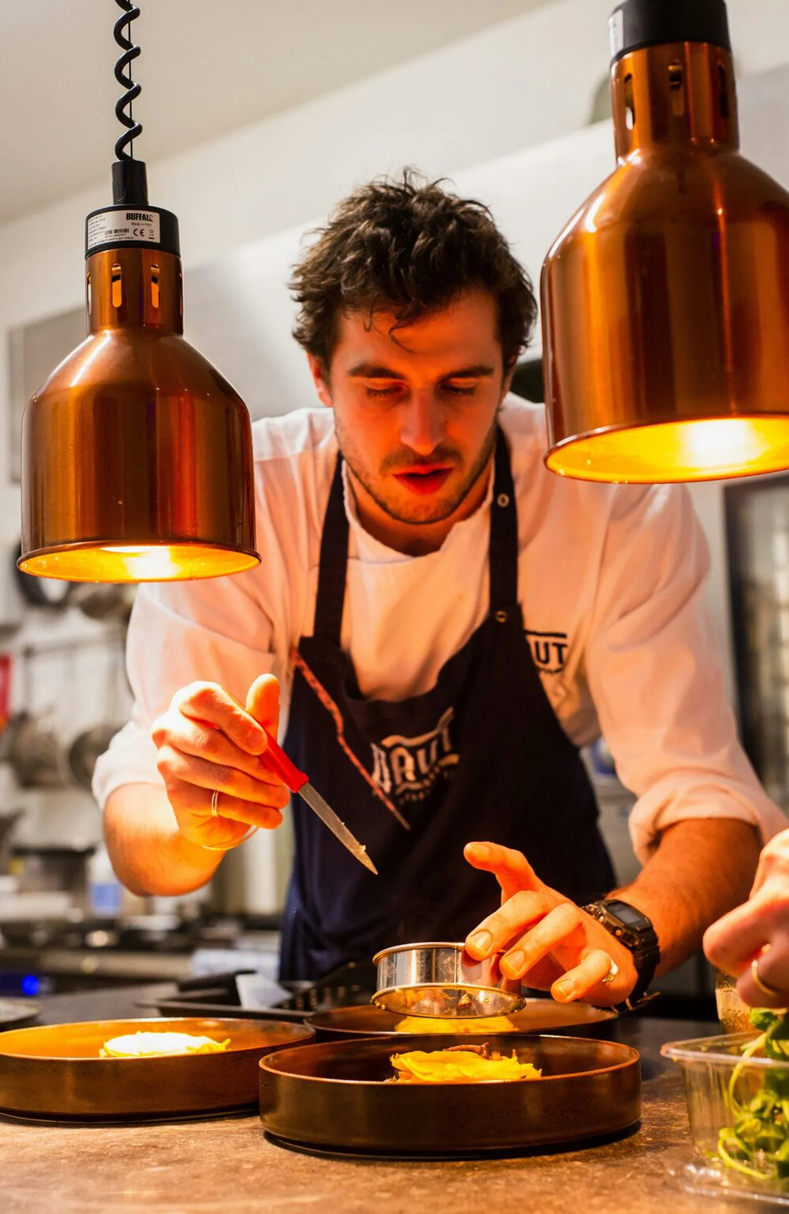 A chef meticulously plating a dish, representing the high-caliber Michelin-starred dining experiences available in Mallorca.