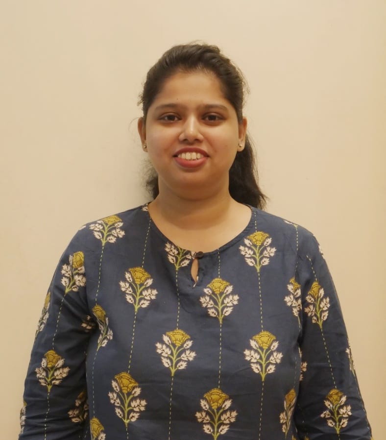 Sakshi smiling in a blue floral kurta, portrait photo