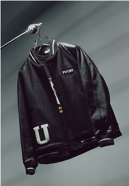 Black varsity jacket with leather sleeves, featuring the word 'PSYCHO' on the chest and a large letter 'U' on the front pocket, hanging on a hanger.