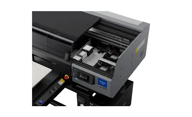 Top view of an open Epson SureColor F2100 direct-to-garment printer showing the printing area and cartridges.