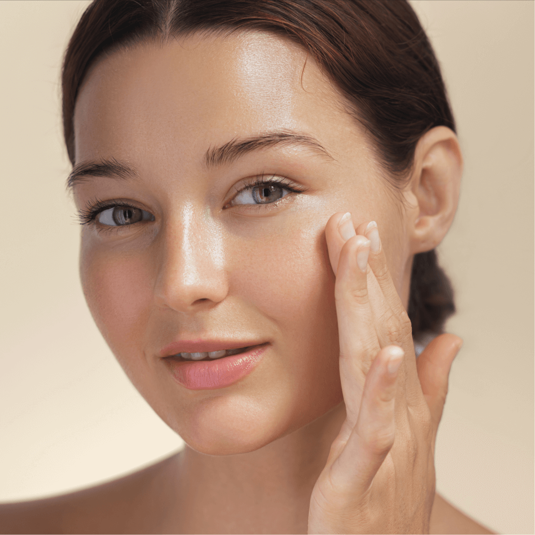 A woman holding her hand up to her face.