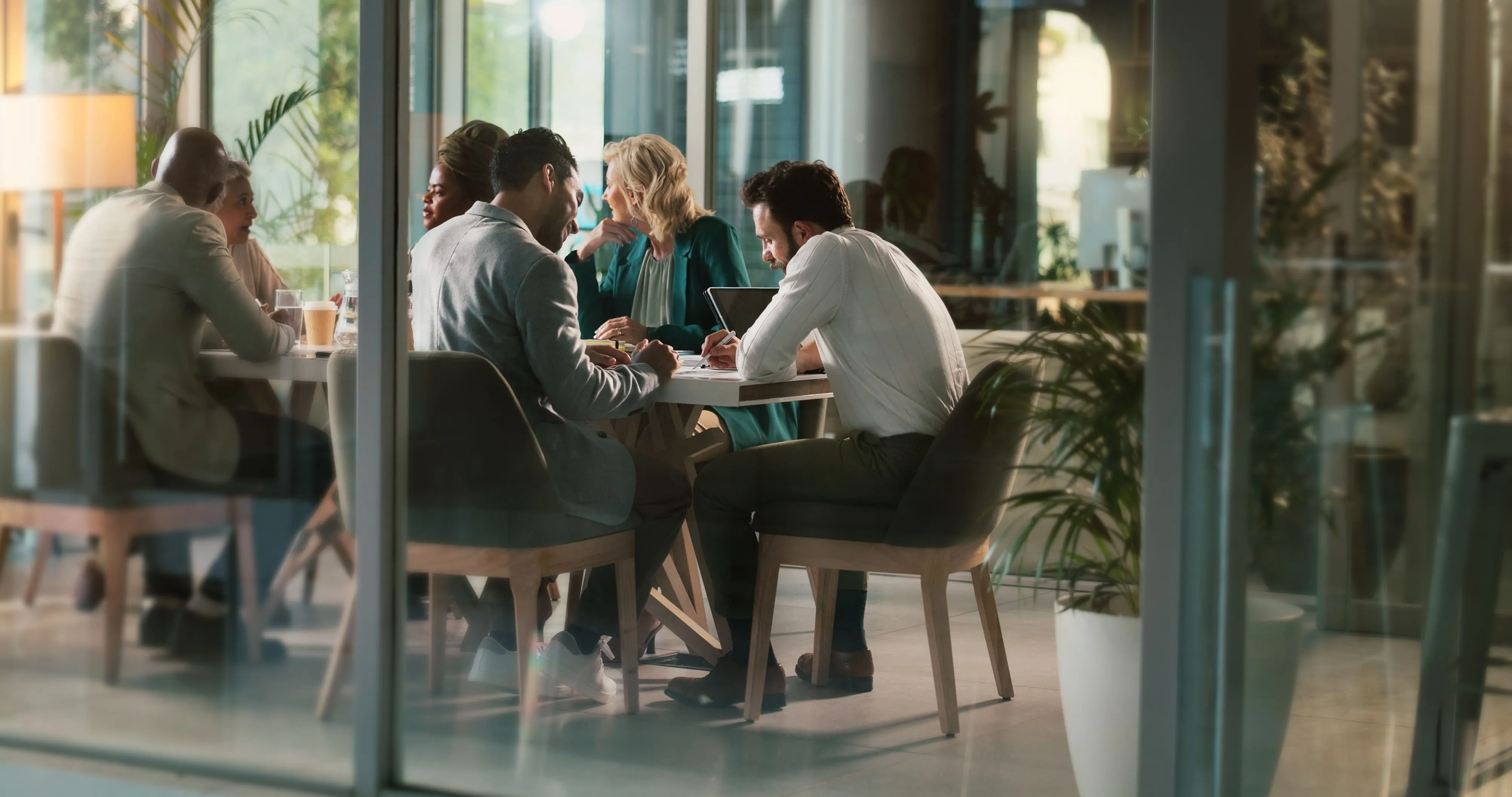 a long-distance shot of people sitting on a desk and talking