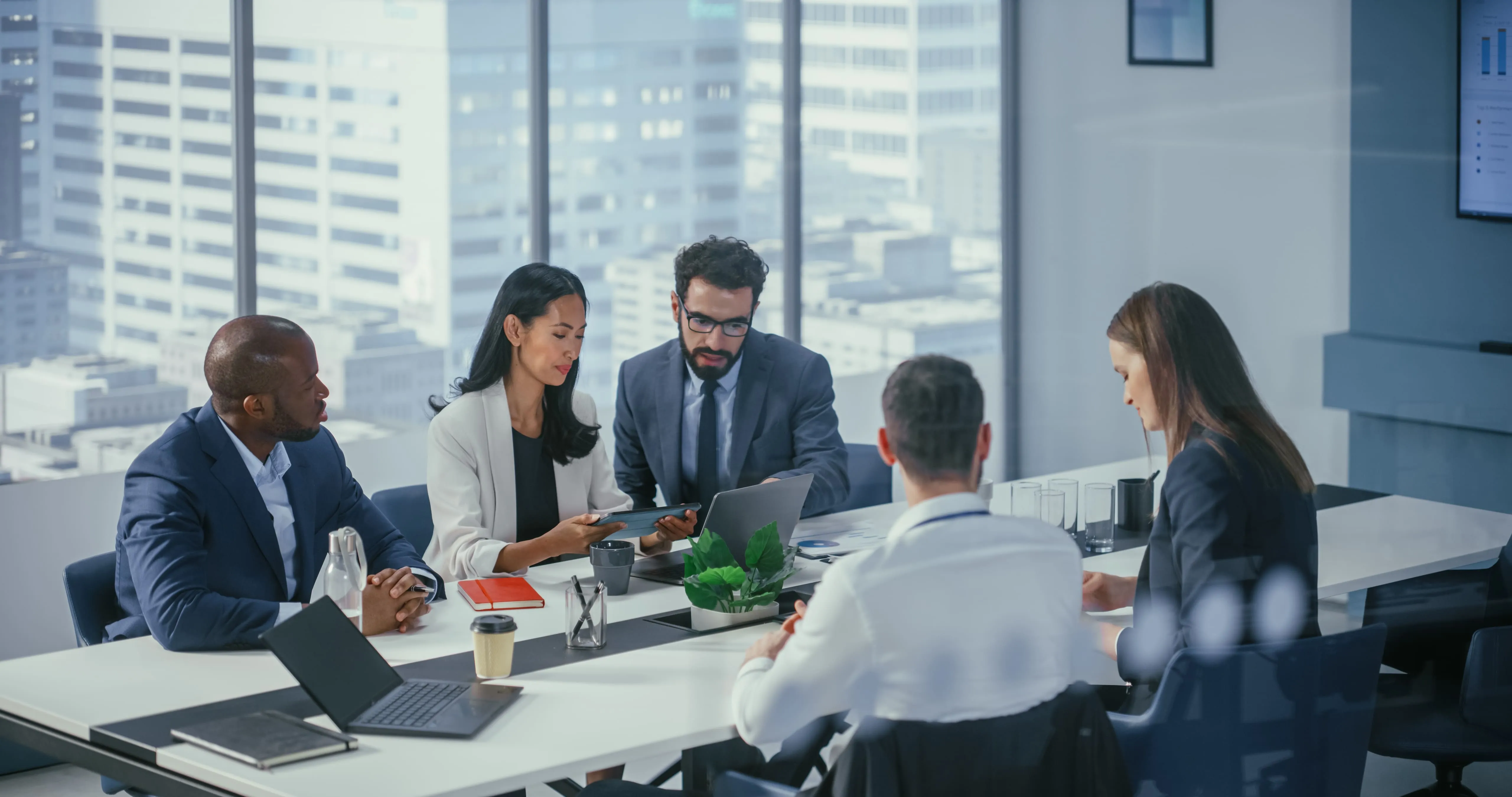 co-workers talking on a desk