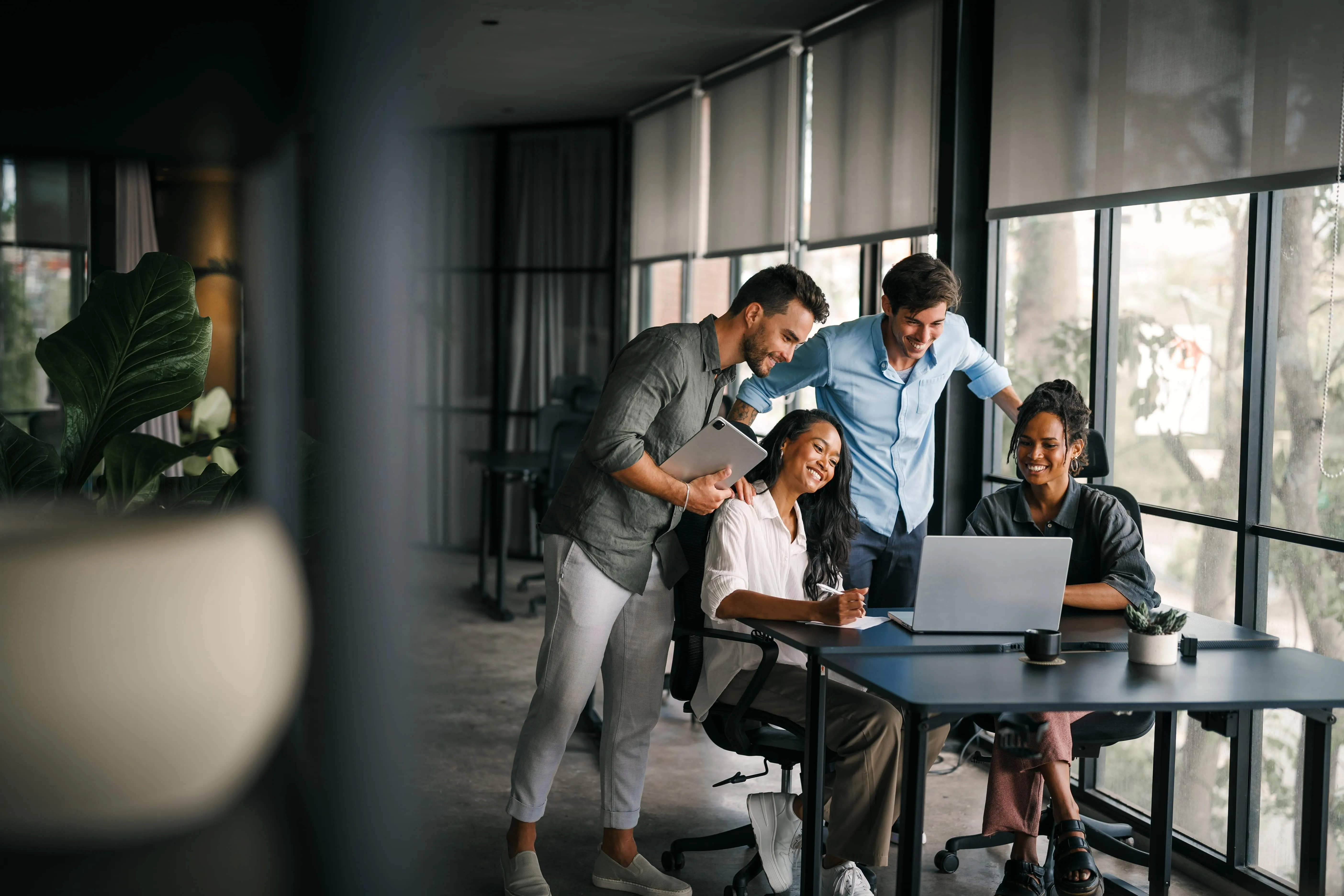 all of the team members in front of the laptop discussing matters