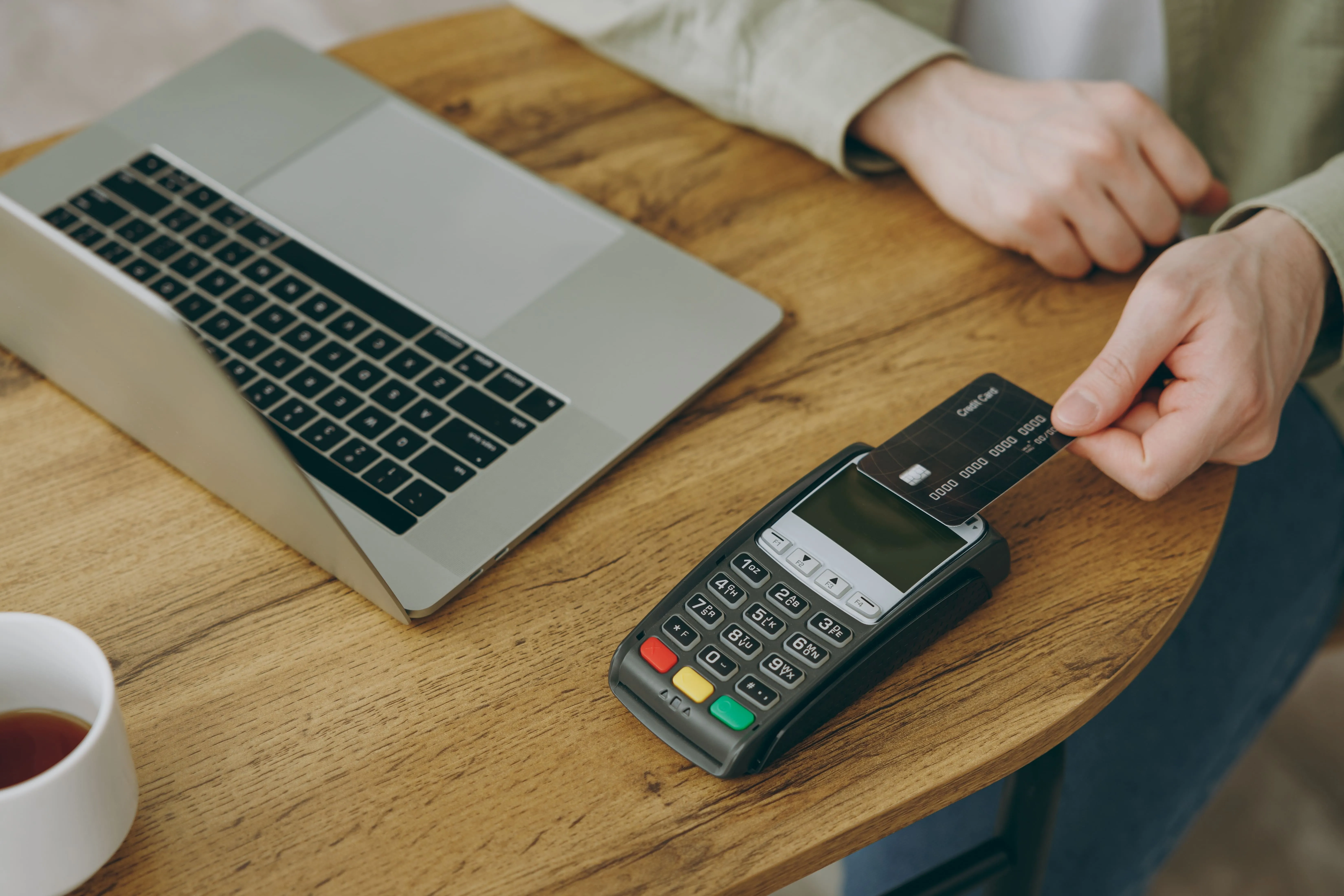 a man paying at the pos terminal