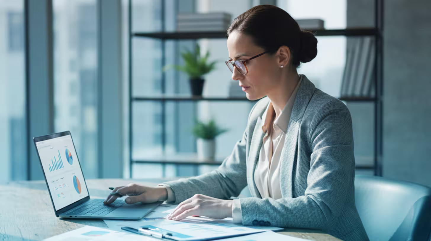 Business team collaborating on laptops and tablet for managed IT services in Minneapolis office