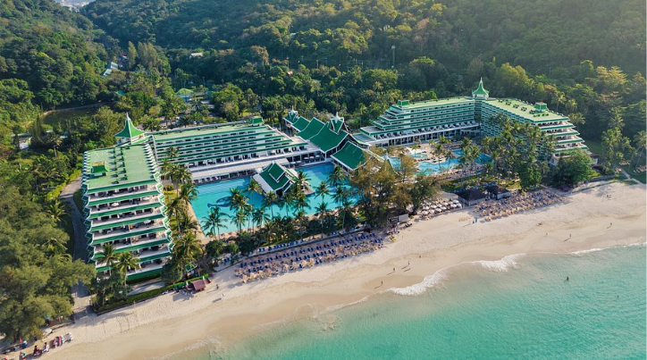 Aerial view of Le Méridien Phuket Beach Resort featuring its iconic beachfront location, turquoise ocean, and lush tropical greenery in Phuket, Thailand.