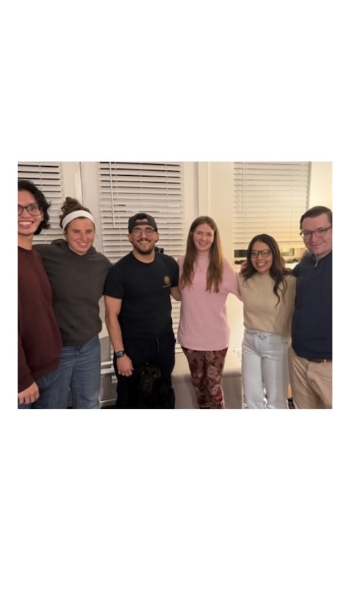A group of people looks into the camera posting for a photo.