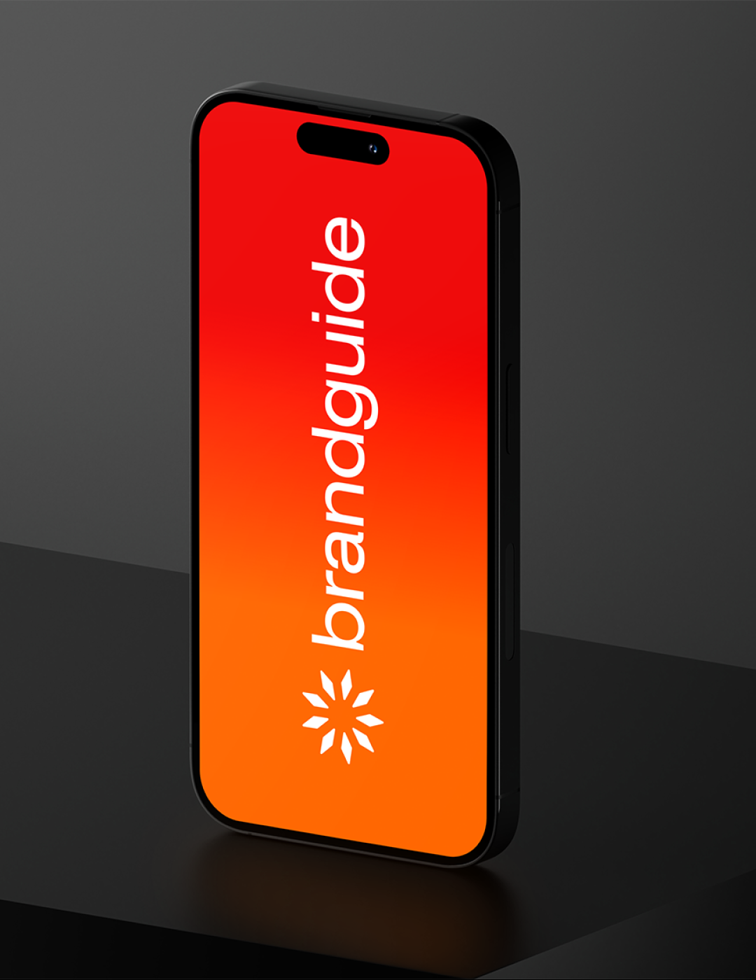 Black smartphone standing vertically on a dark surface with a red-to-orange gradient screen displaying the white text 'brandguide' and a white geometric logo below it.
