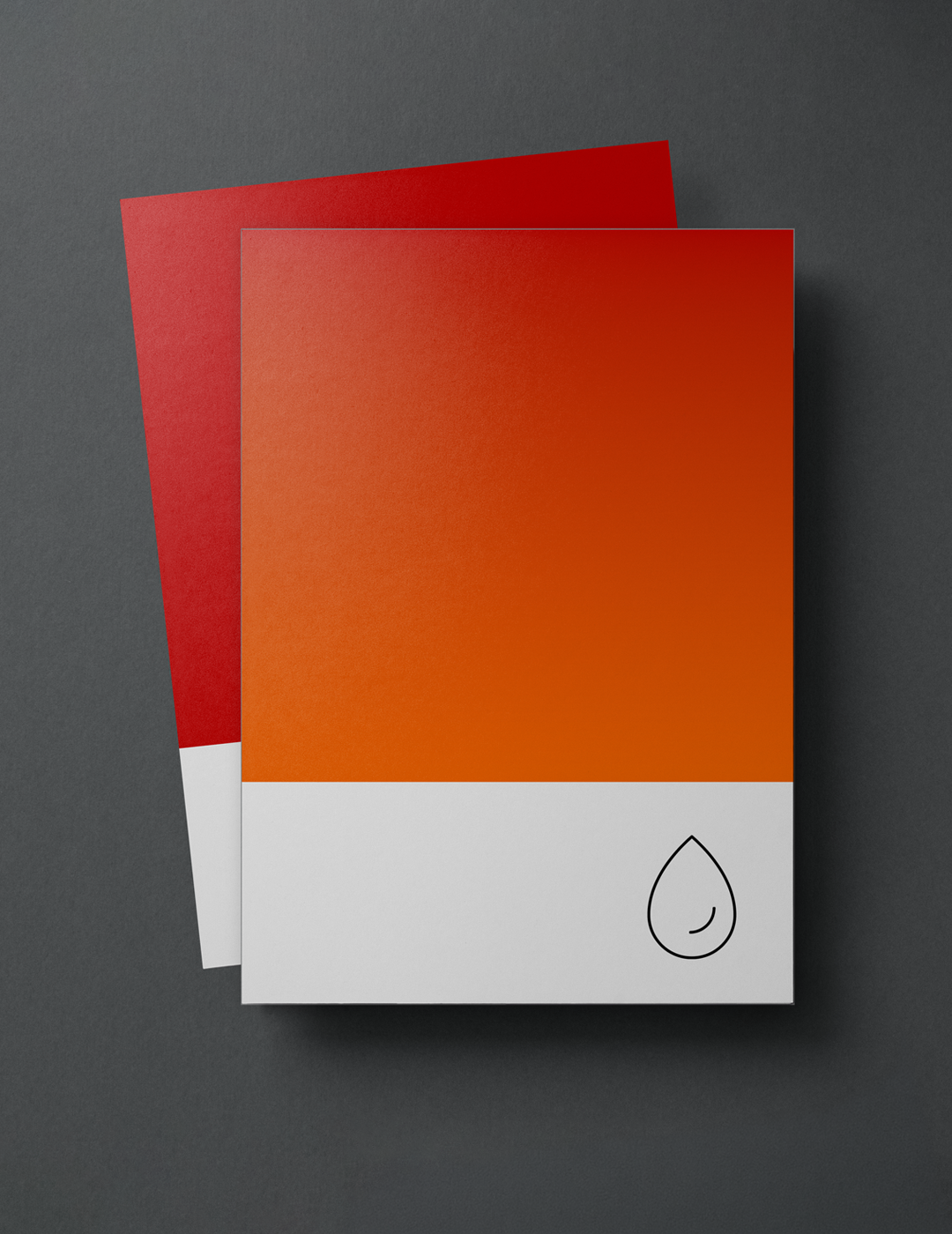 Two color swatches on a dark gray surface, one red underneath and one orange on top with a small black outlined droplet icon in the bottom right corner.