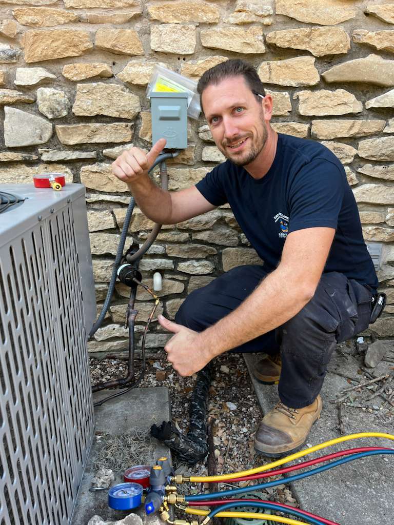 Professional HVAC technician working on residential air conditioning system in Central Texas home#1.8