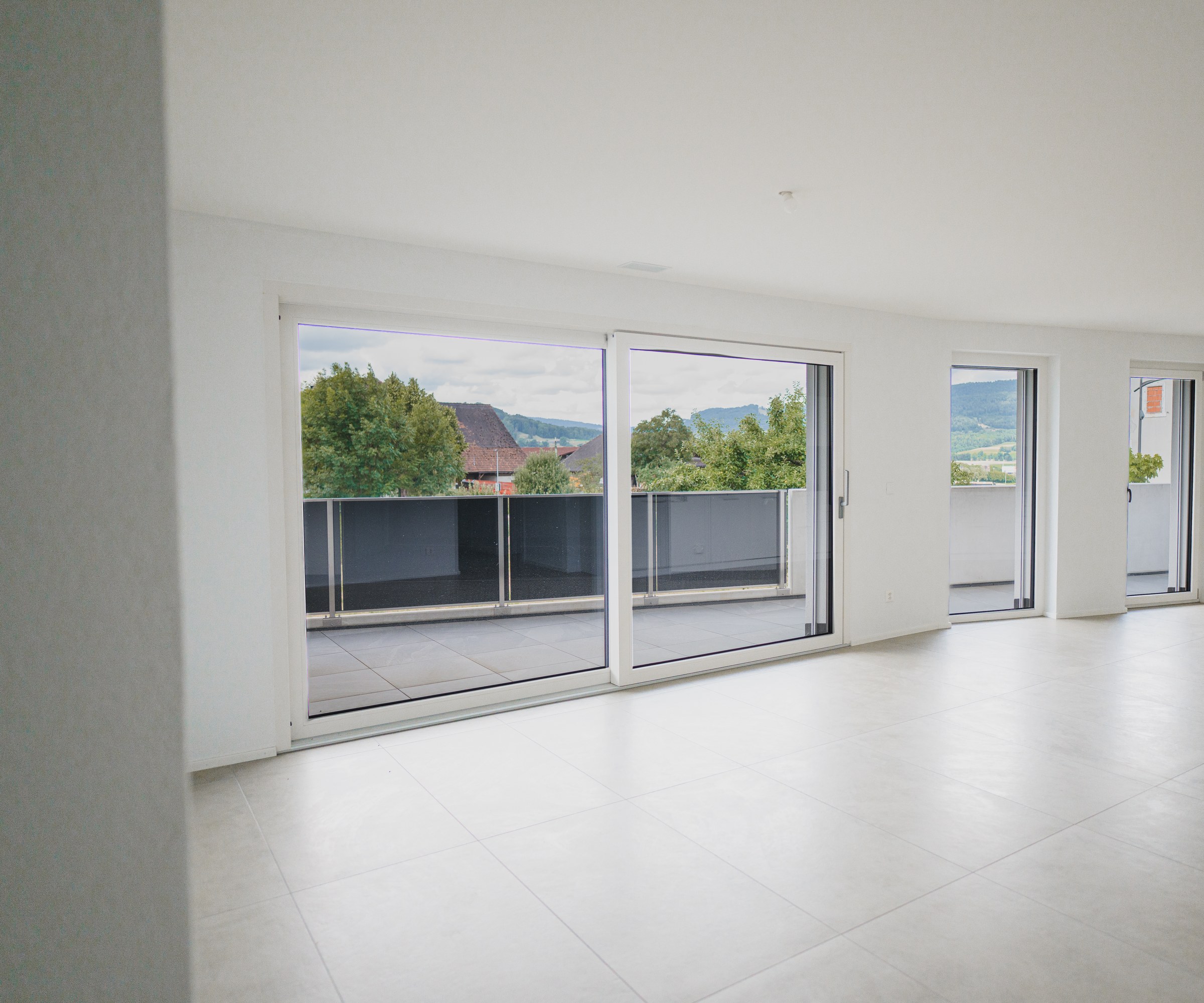 Séjour équipé de fenêtres et baies coulissantes PVC blanches Domofen DomoPure