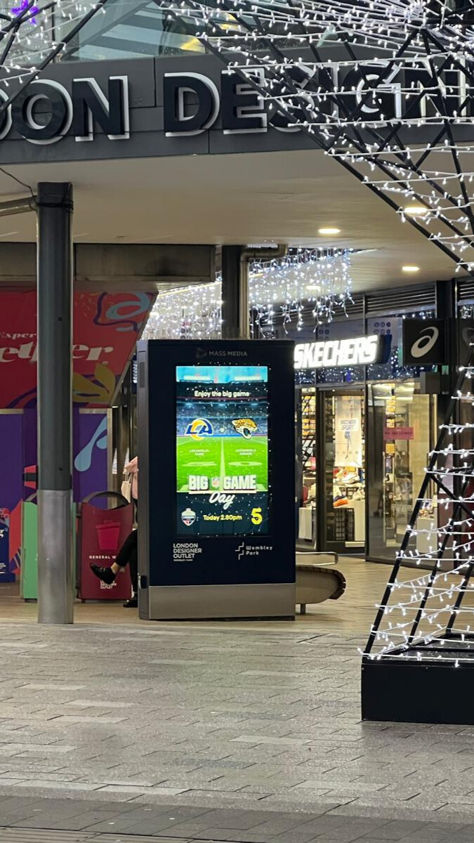 Digital display at London Designer Outlet promoting the NFL Big Game day featuring Los Angeles Rams and Jacksonville Jaguars logos.