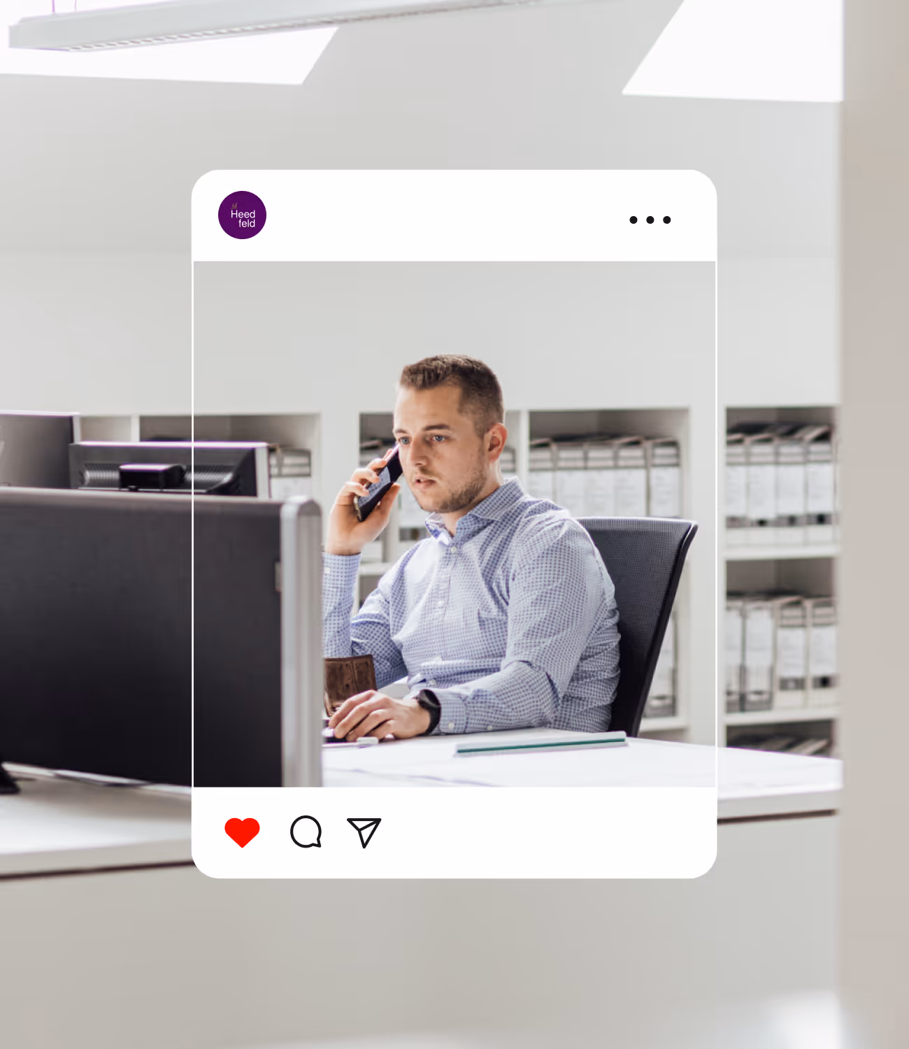 Man aan het werk op kantoor, aan de telefoon achter zijn computer, in een helder en modern interieur met archiefkasten op de achtergrond.