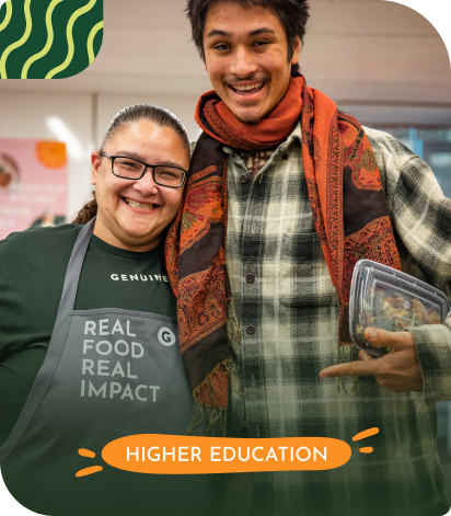 Two smiling people, one wearing an apron that says 'Real Food Real Impact,' posing together with an orange banner reading 'Higher Education.'