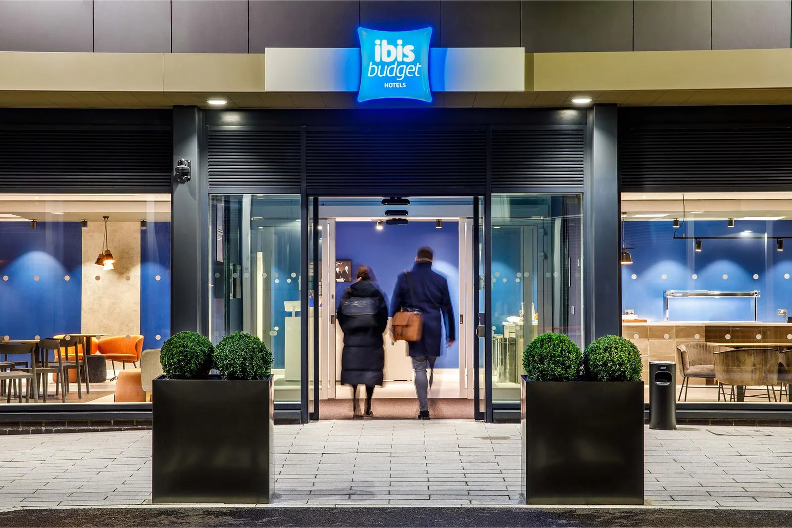 two guests entering the doors of Ibis Budget Manchester Airport