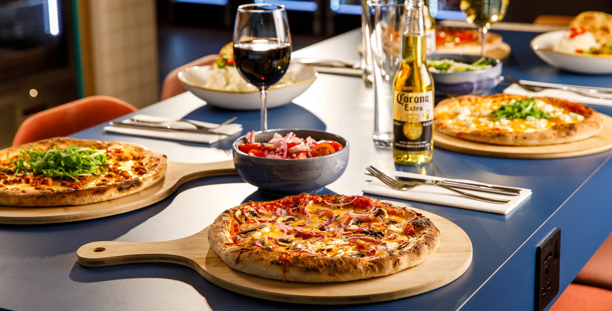 Close up look of table with wine and pizza at Ibis Hotel Manchester Airport
