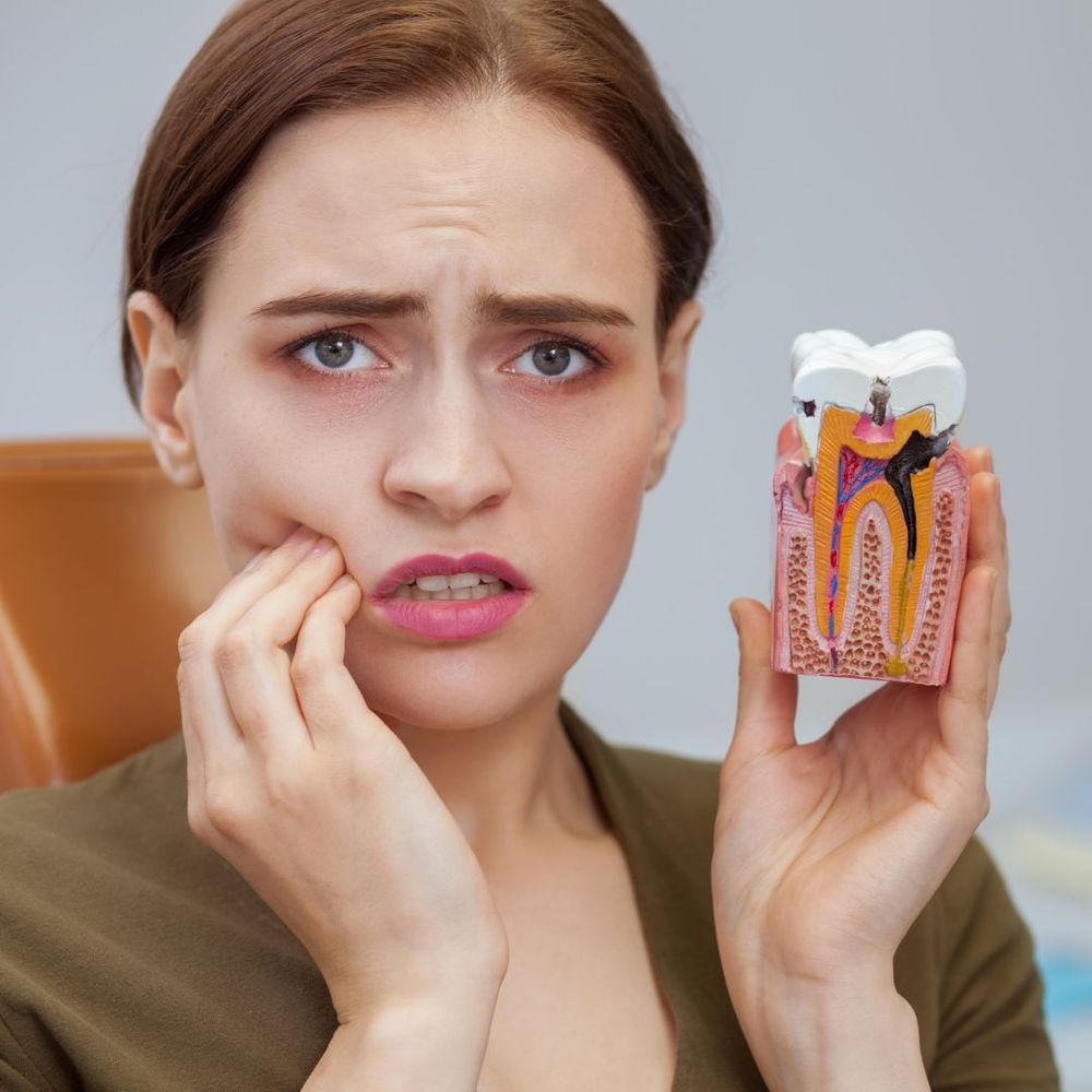 woman with cavity holding model of cavity