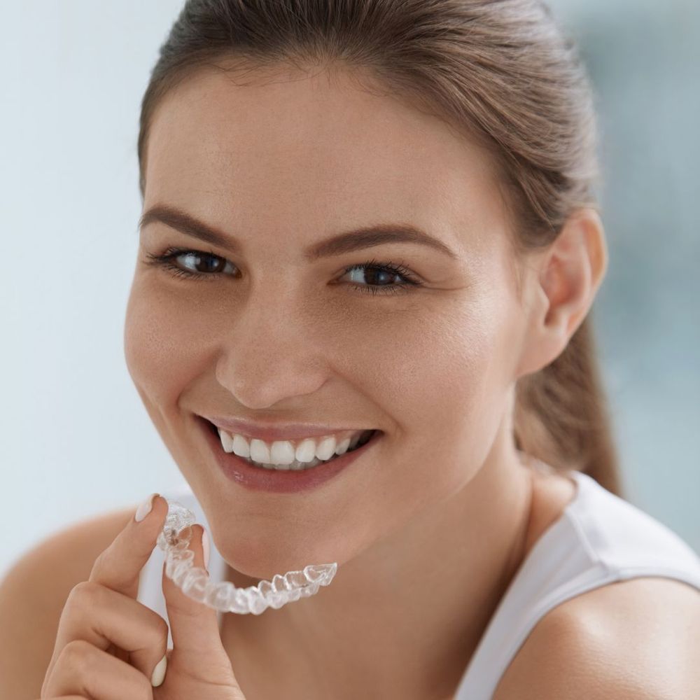 young woman with invisible aligner